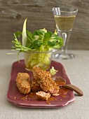 Salmon in sesame crust with apricot sauce and salad leaves