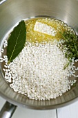 Sweating rice with butter and herbs in a sauteuse pan