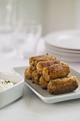 Fried carrot rolls with herb yoghurt