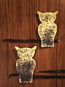 Two owl-shaped vanilla biscuits with poppy seeds