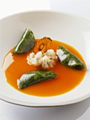 A plate of carrot bouillon with herb jelly