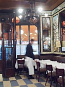 French restaurant interior with one waiter