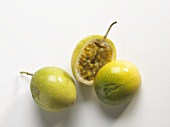 Whole and halved green passion fruit