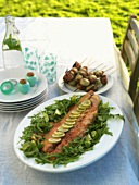 Grilled salmon on rocket and lime with skewered vegetables
