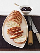 Bacon-wrapped chicken terrine, partly sliced