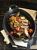 Roast beef and vegetables cooked in a cast-iron dish