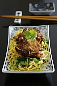 Teriyaki chicken thighs on fried garlic noodles