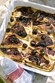 Bread and butter pudding with blueberries in a baking dish