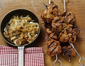 Grilled pork kebabs with fried onions