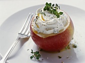 An apple filled with herb cream cheese