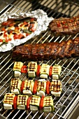 Pork ribs, courgette kebabs, charr, steak on barbecue