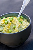 Pea puree with candied lemon peel in a bowl