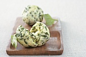 Ricotta and basil dumplings on a wooden board