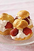 Three profiteroles filled with strawberries & whipped cream