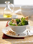 Fried chicken skewers with broccoli and sesame seeds