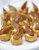 Sausages on mustard mashed potato in shortcrust pastry shells