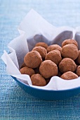 Chocolate truffles in a bowl with paper
