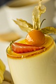 Fruit cream in glass with physalis and strawberry