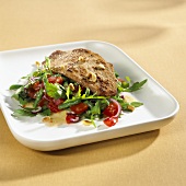 Veal escalope on bean, rocket and tomato salad