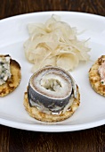 Blinis with smoked salmon, herring, horseradish and fennel