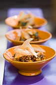 Three small bowls of lentil and carrot salad