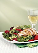Salad leaves with roast chicken breast and strawberries