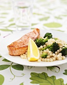 Fried salmon with lemon sauce, couscous and broccoli