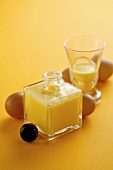 Advocaat in a bottle and a glass with fresh eggs