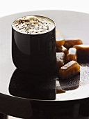 A beaker of café frappé with coffee ice cubes