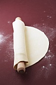 Rolled-out pastry with a rolling pin