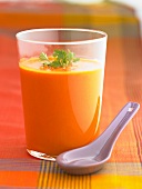 Red pepper and ginger soup in a glass with chervil