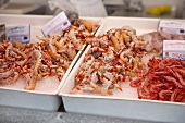 Prawns and langostinos on crushed ice at a fish market