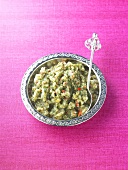 Minted onion chutney in a dish with a spoon
