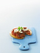 Small puff pastry pizza topped with chorizo, tomatoes & Parmesan