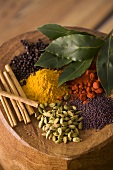 Assorted exotic spices on wooden background