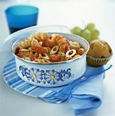 Pasta salad with sausage, tomatoes, spring onions, tomato sauce