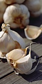 Garlic bulbs and cloves on wooden background