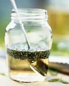 Herb dressing in a jar with spoon