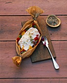 Cod with peppers in parchment paper, mixed pepper