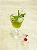 A glass of coconut drink with verbena