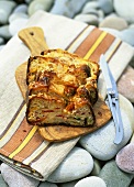 Red pepper bread, sliced, on wooden board