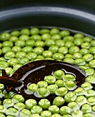 Peas floating in water