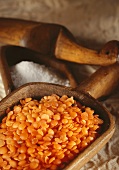 Red lentils in a wooden scoop