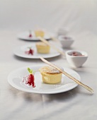 Vanilla soufflés with raspberry sauce and rhubarb in dishes