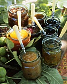 Various jams in jars with spoons