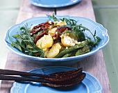 Potato salad with beans, rocket and dried tomatoes
