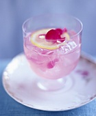 Cocktail mit Rosenblütenblättern