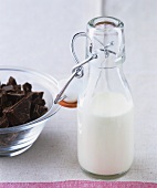A bottle of cream and chopped chocolate for ganache