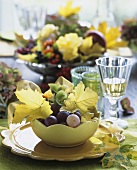 Bowls of fruit with autumn flowers and leaves