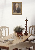 Dining table with crockery, cutlery and candlestick